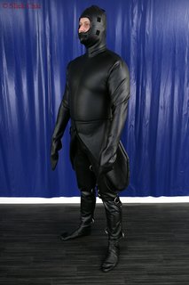 Punishment suit with d-rings and belts
